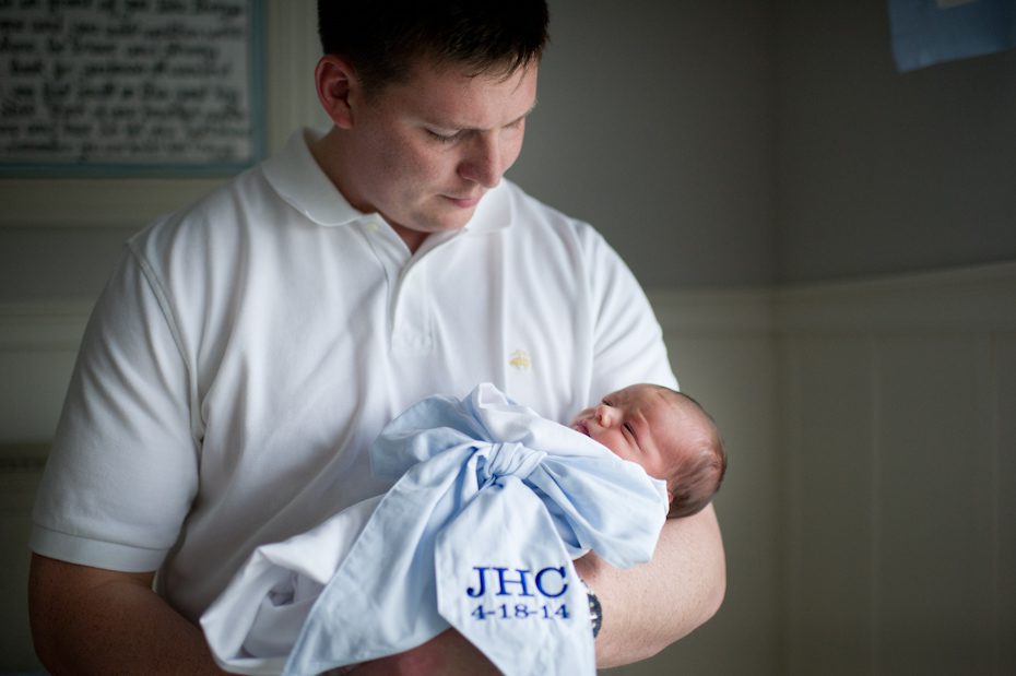 Dad holding newborn son